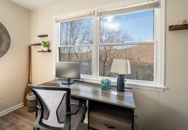 a bedroom with bed a couch and dresser next to a window