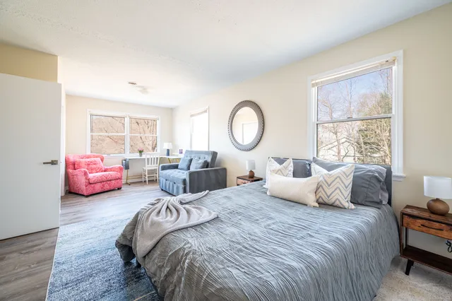 a bedroom with bed and a large window