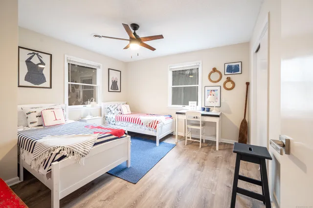 a bedroom with two beds and a window