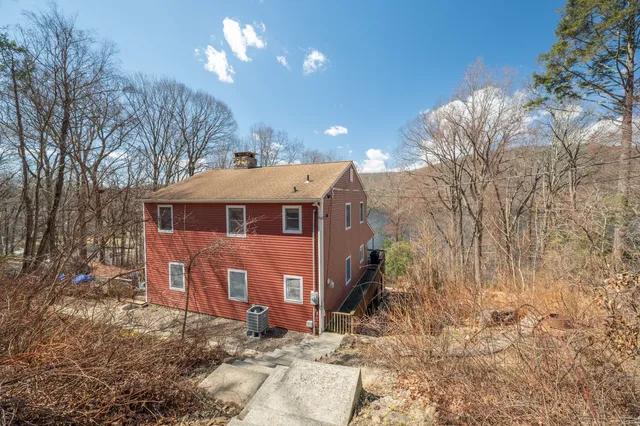 a balcony of a house with table and chairs