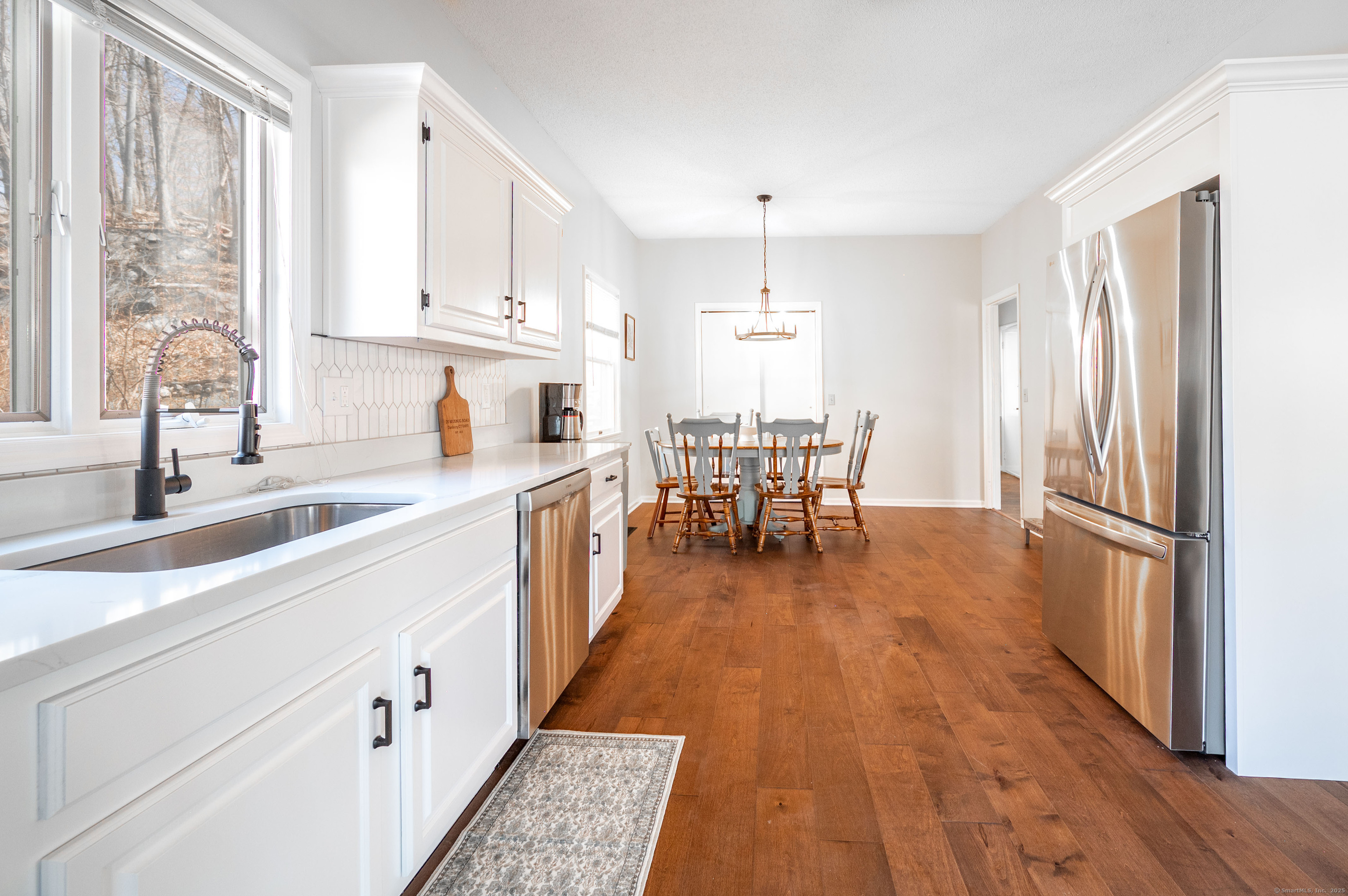20 Musnug Road Danbury, CT 06811 - Photo 9 of 39 a kitchen with granite countertop a sink appliances cabinets and wooden floor