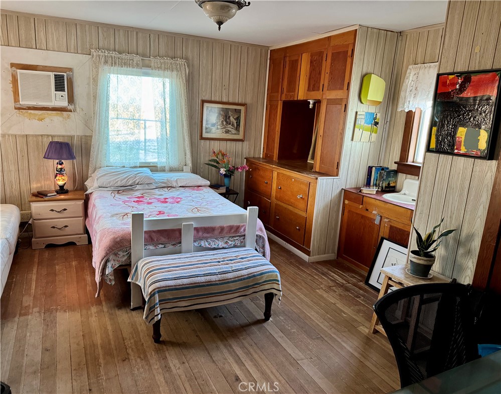 4759 Pinto Mountain Road Twentynine Palms, CA 92277 - Photo 15 of 21 a bedroom with a bed closet and a flat tv screen
