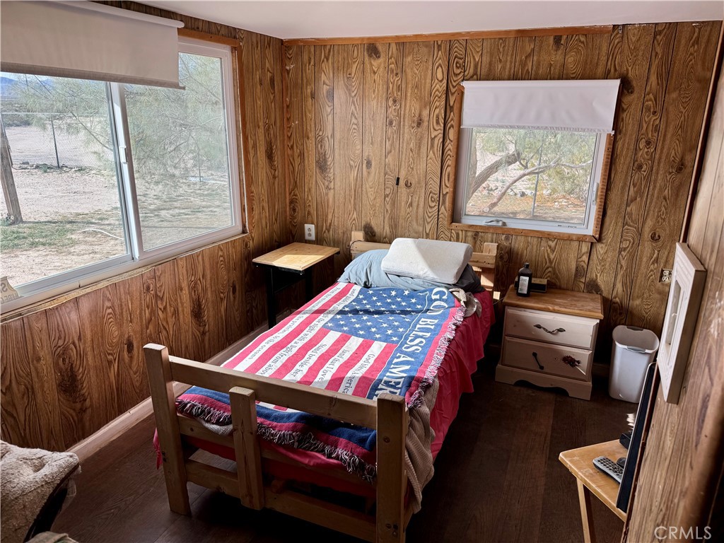 4759 Pinto Mountain Road Twentynine Palms, CA 92277 - Photo 16 of 21 a bedroom with a bed and wooden floor