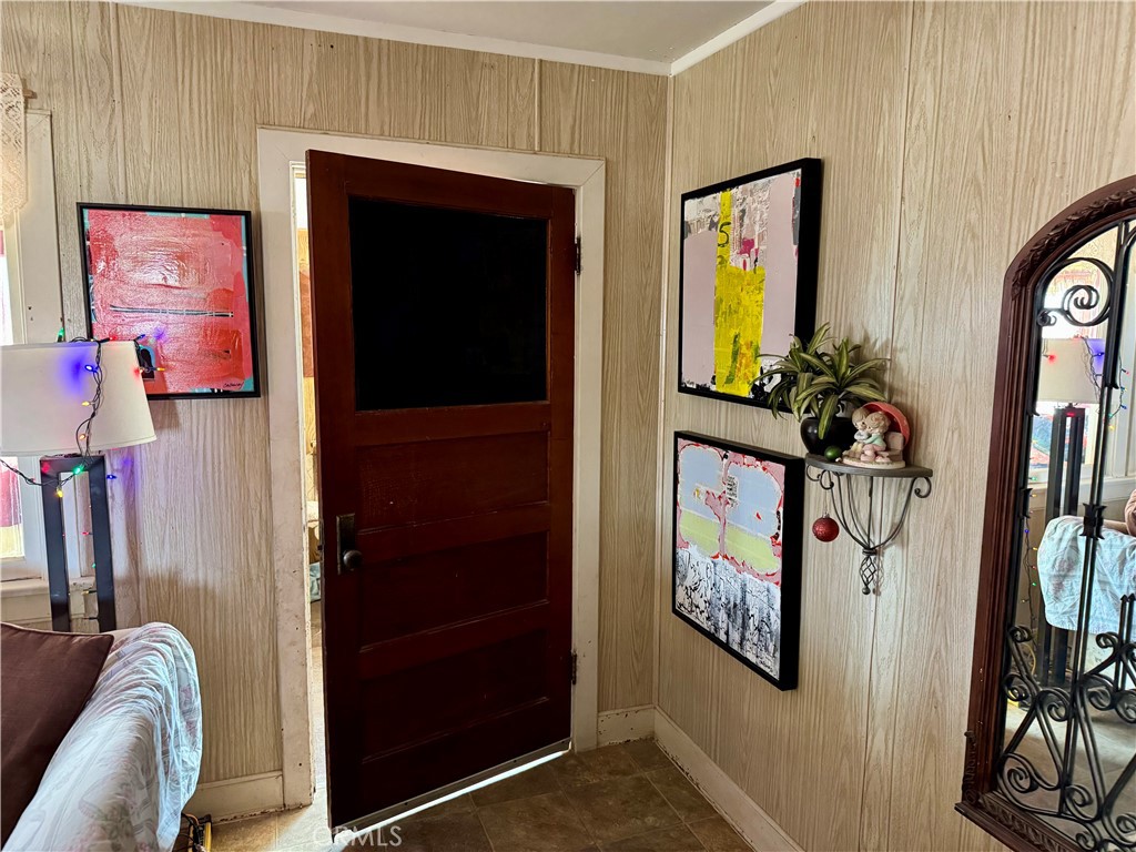 4759 Pinto Mountain Road Twentynine Palms, CA 92277 - Photo 7 of 21 a view of a hallway with wooden floor and windows
