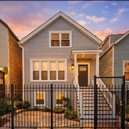 a view of a house with wooden fence