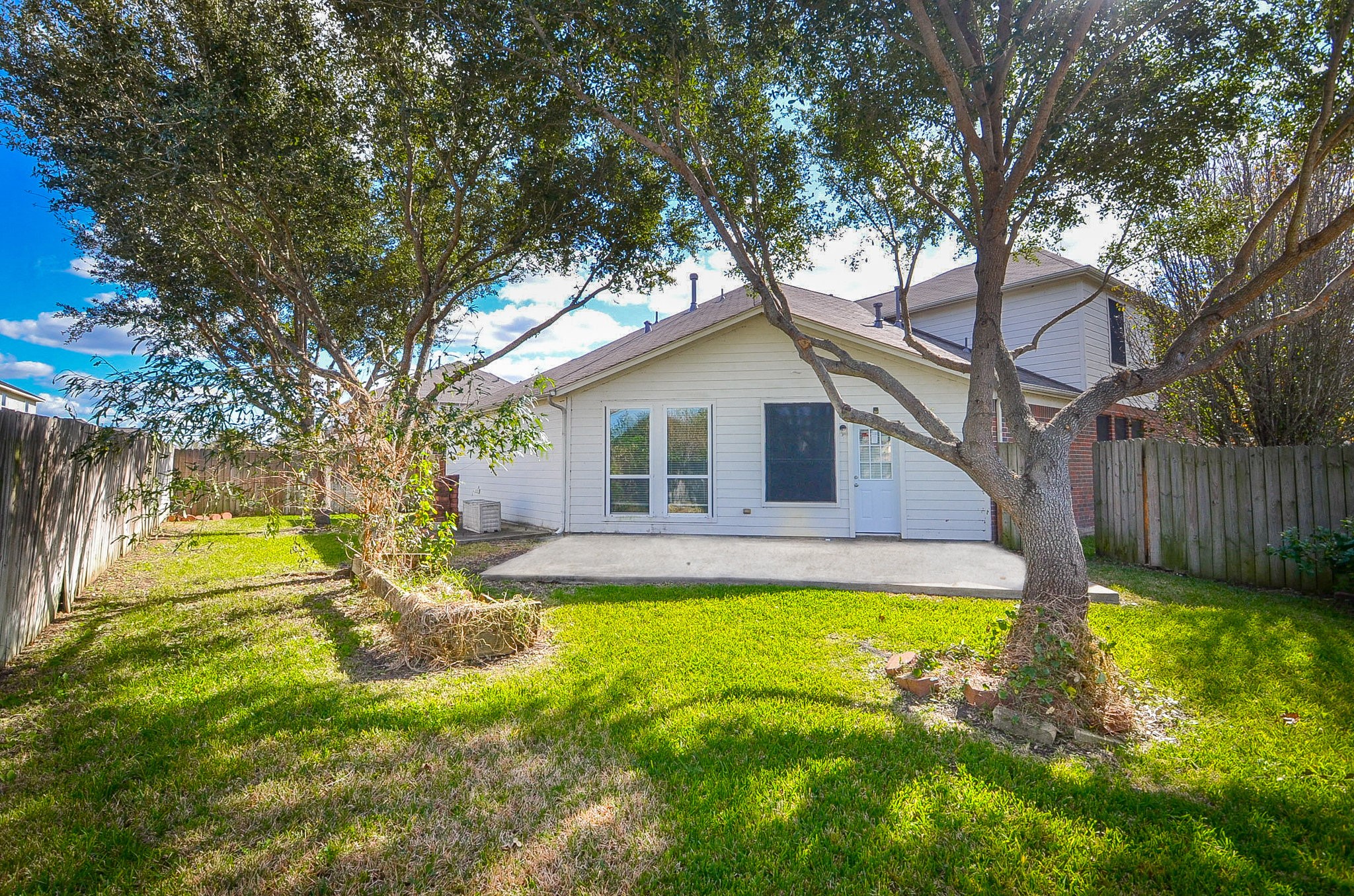 3003 Sage Grouse Court Rosenberg, TX 77471 - Photo 34 of 34 a view of a house with a big yard potted plants and large tree