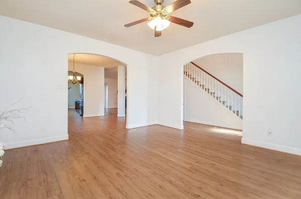 a view of an empty room with wooden floor