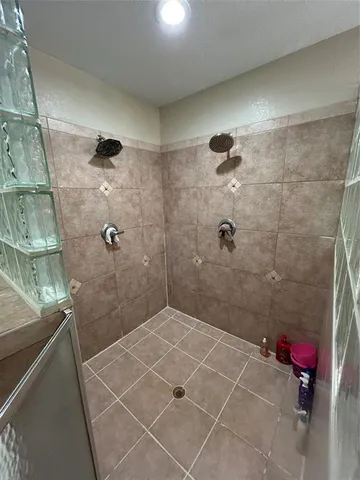 a spacious bathroom with a tub sink and mirror
