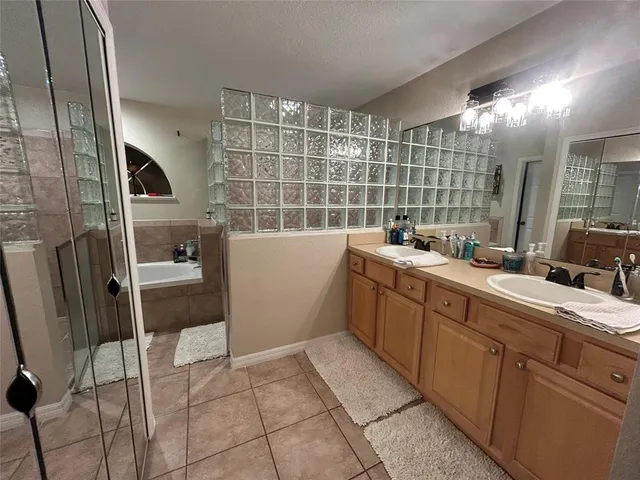 a spacious bedroom with a bed and a chandelier