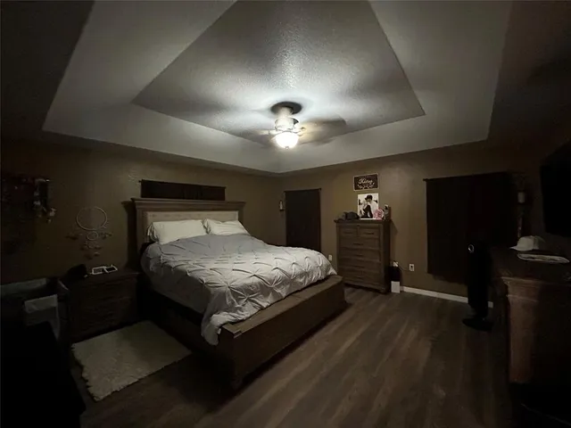 a large bed sitting in a bedroom next to a cabinet
