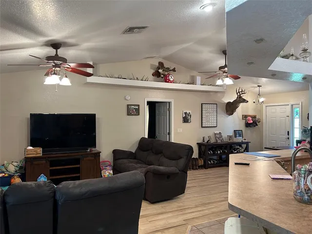 a kitchen with cabinets stainless steel appliances and wooden floor