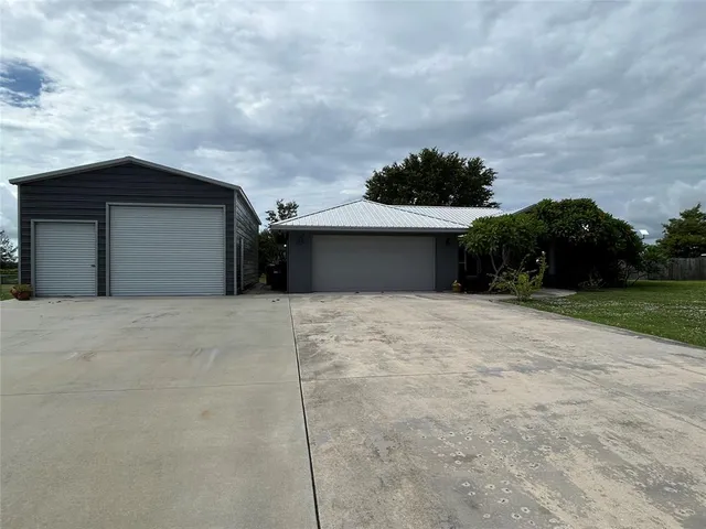 a view of a wooden house with a yard
