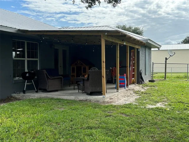 a view of a backyard with table and chairs