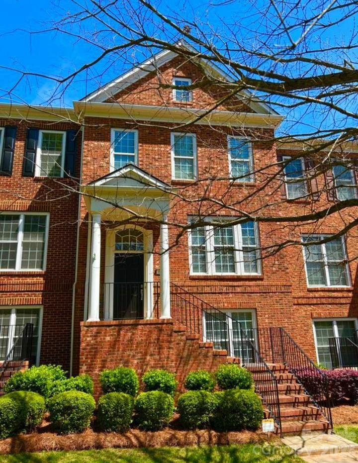 a view of a brick building next to a yard