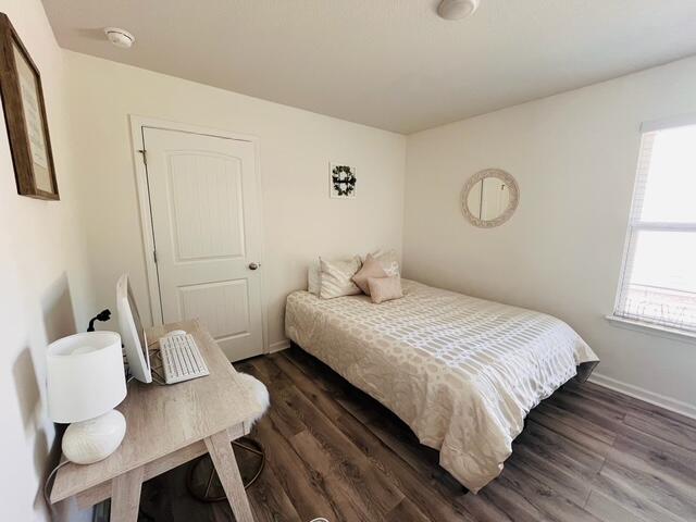 473 Earl Godwin Road Freeport, FL 32439 - Photo 11 of 25 a bedroom with a bed and wooden floor