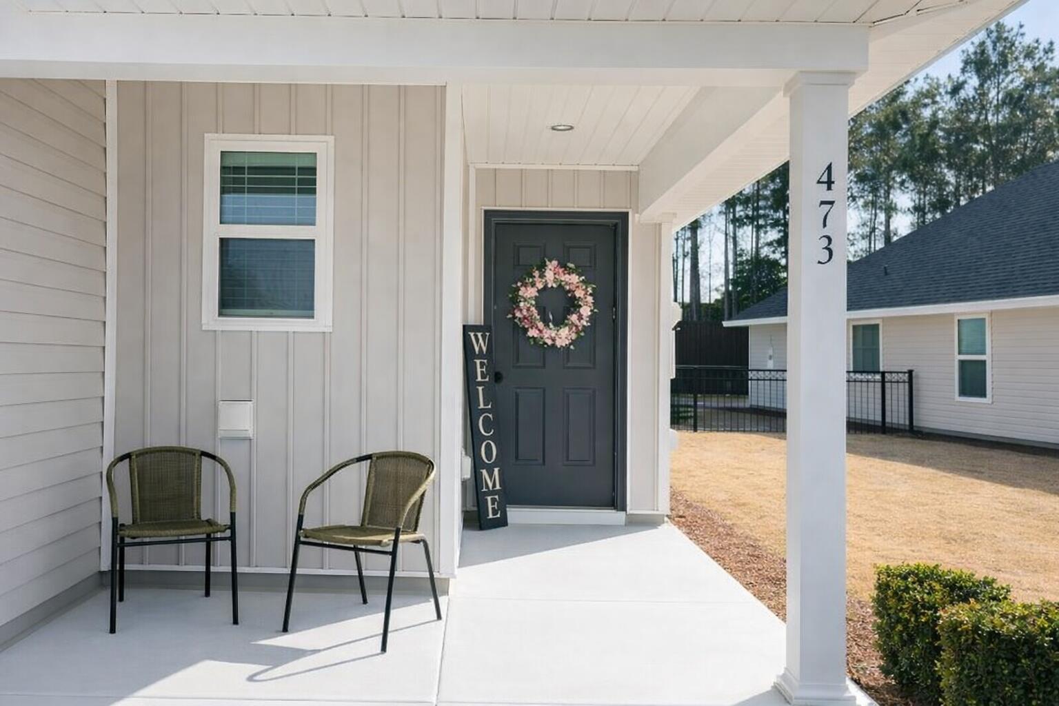 473 Earl Godwin Road Freeport, FL 32439 - Photo 2 of 25 a balcony view with two chairs and a potted plant