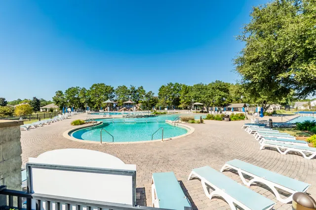 a swimming pool with outdoor seating and yard