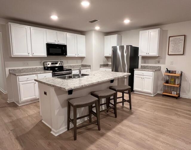 473 Earl Godwin Road Freeport, FL 32439 - Photo 4 of 25 a kitchen with white cabinets and stainless steel appliances