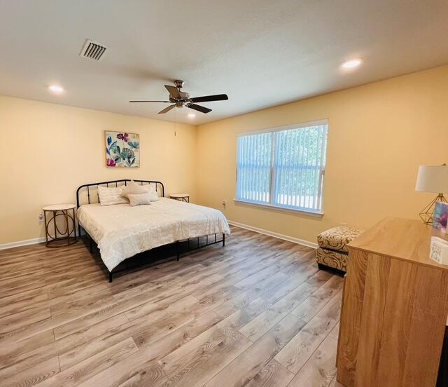 473 Earl Godwin Road Freeport, FL 32439 - Photo 6 of 25 a bedroom with a bed and wooden floor