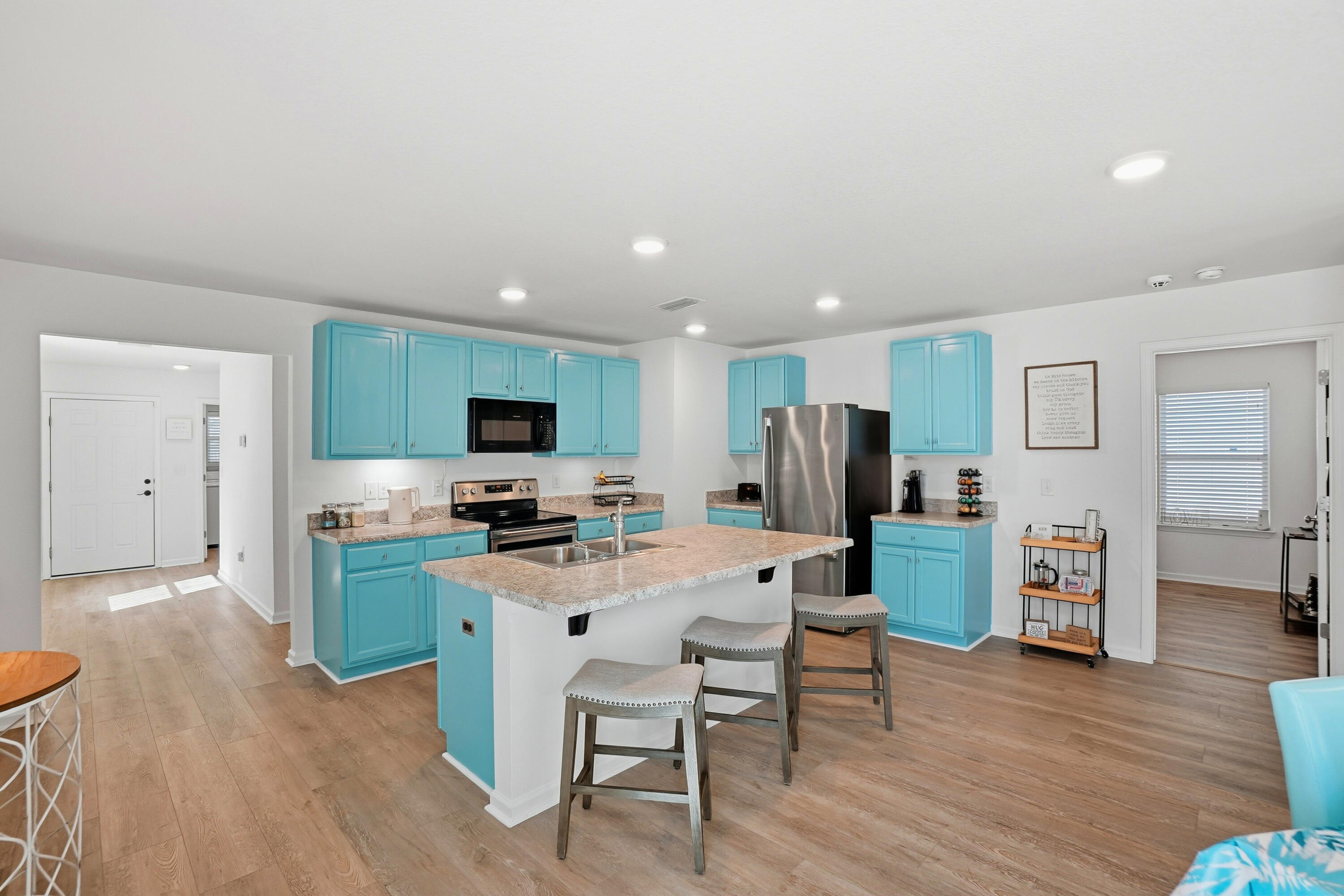 473 Earl Godwin Road Freeport, FL 32439 - Photo 6 of 29 a living room with furniture a flat screen tv and kitchen view