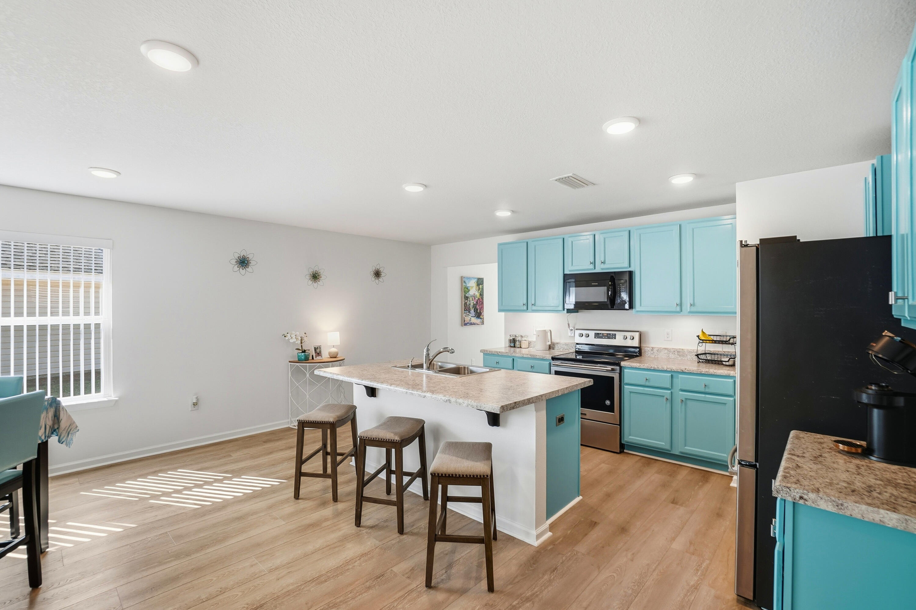 473 Earl Godwin Road Freeport, FL 32439 - Photo 7 of 29 a kitchen with cabinets and wooden floor