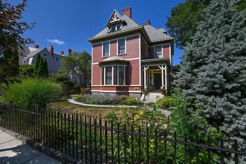 a front view of a house with a garden