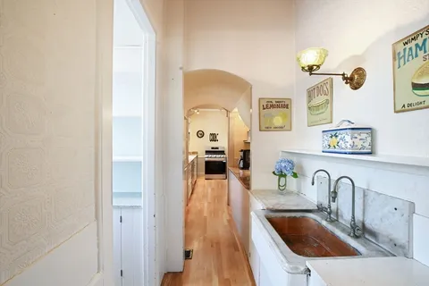 a kitchen with a sink cabinets and a stove