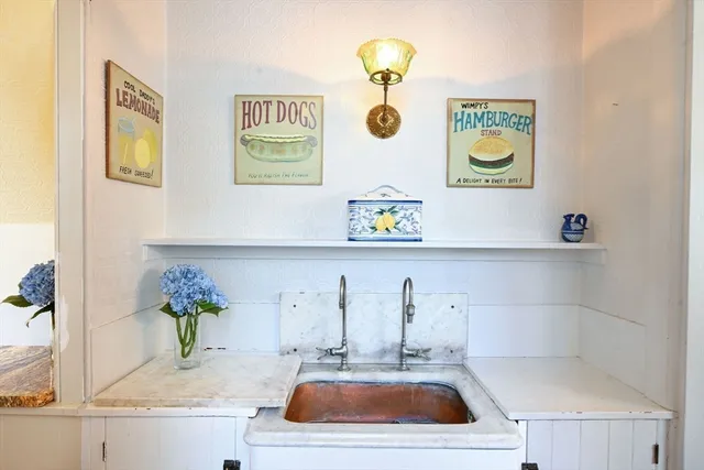 a kitchen with a sink and a stove top oven