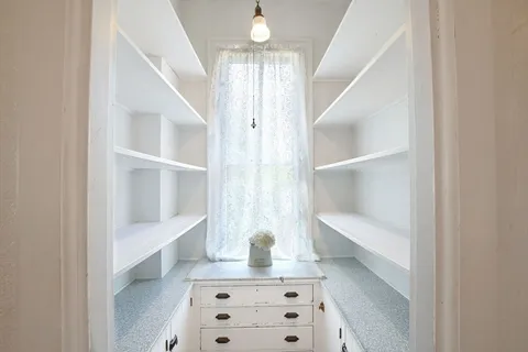 a view of staircase with white walls and a window