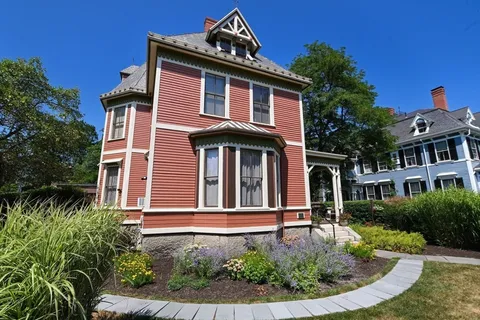 a front view of a house with garden