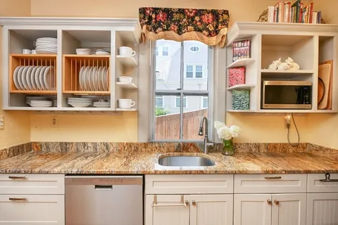 a kitchen with granite countertop a sink and a window