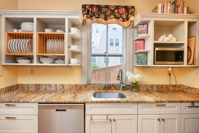 a kitchen with granite countertop a sink and a window