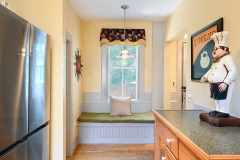 a kitchen with stainless steel appliances granite countertop a sink and a refrigerator