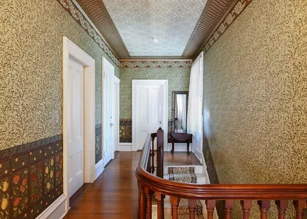 a view of living room with furniture and wooden floor