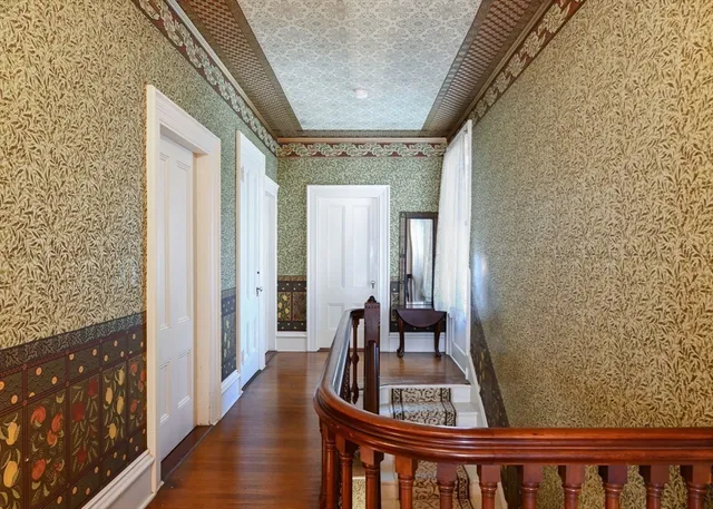 a view of living room with furniture and wooden floor