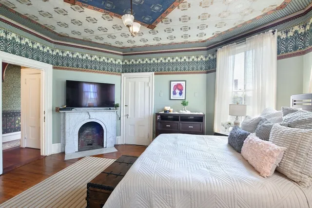 a spacious bedroom with a bed and a fireplace