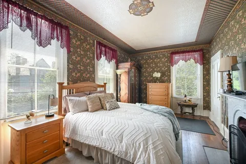 a bedroom with a balcony a large bed and a window