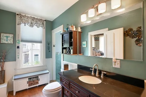 a bathroom with a sink a toilet and a mirror