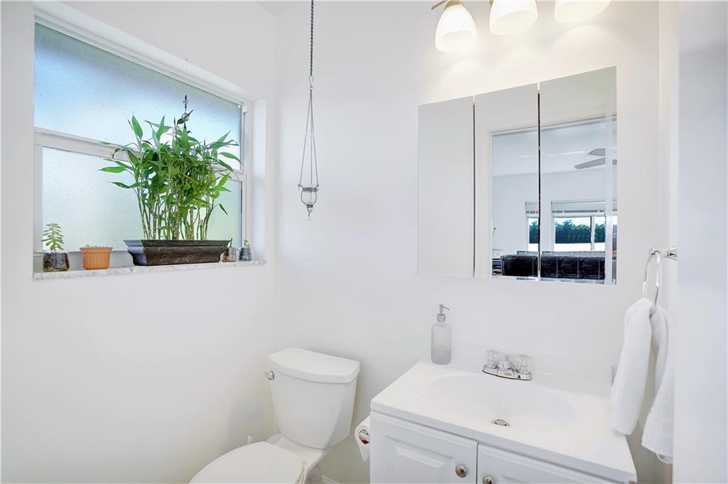 5700 Northeast 22nd Way, Unit 322 Fort Lauderdale, FL 33308 - Photo 14 of 19 a bathroom with a sink a toilet and a mirror