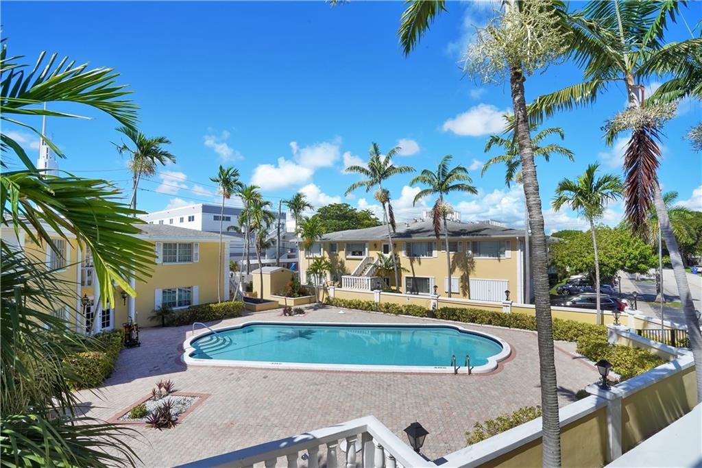 5700 Northeast 22nd Way, Unit 322 Fort Lauderdale, FL 33308 - Photo 15 of 19 a view of a swimming pool with a patio