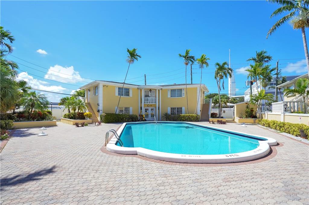 5700 Northeast 22nd Way, Unit 322 Fort Lauderdale, FL 33308 - Photo 16 of 19 a view of outdoor space yard swimming pool and outdoor seating