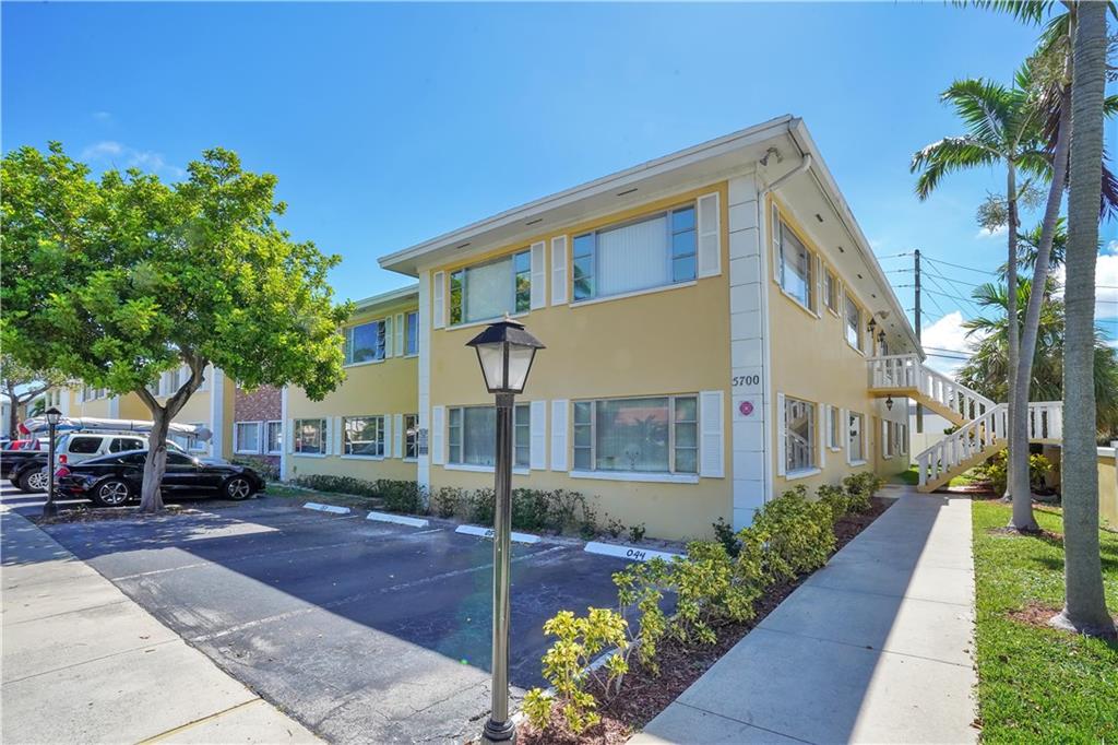 5700 Northeast 22nd Way, Unit 322 Fort Lauderdale, FL 33308 - Photo 18 of 19 a front view of a house with a yard and trees