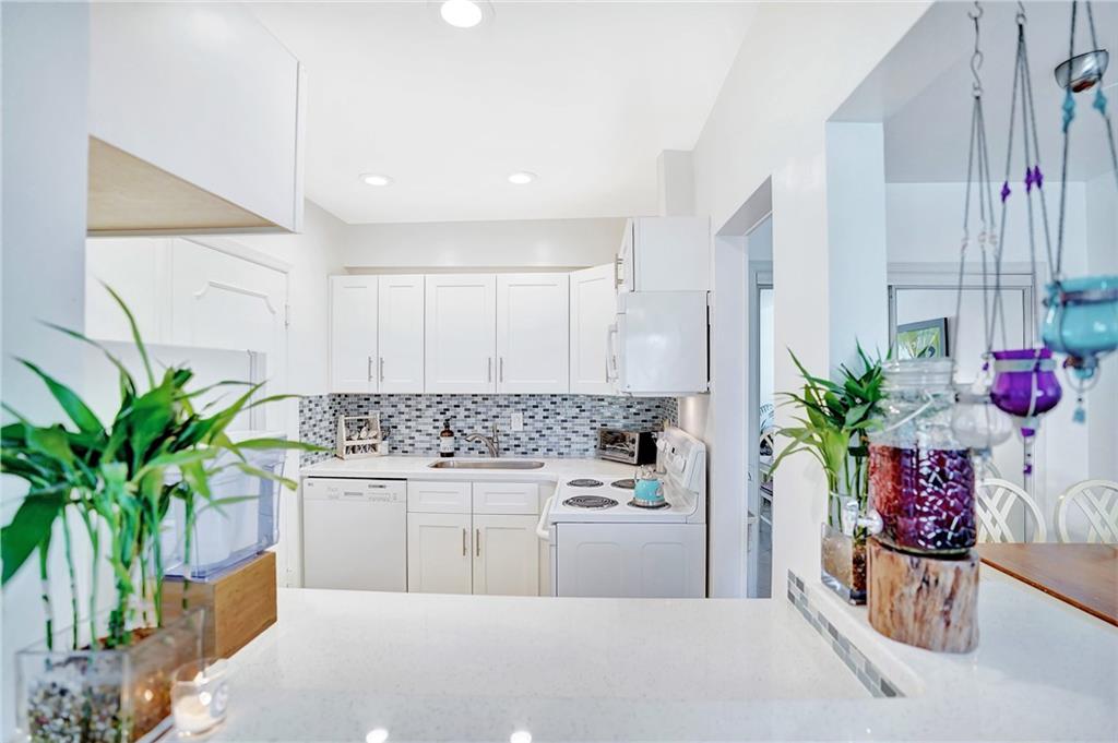 5700 Northeast 22nd Way, Unit 322 Fort Lauderdale, FL 33308 - Photo 2 of 19 a kitchen with a potted plant on the counter and sink