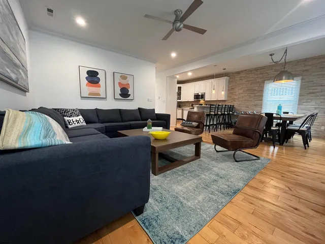 a living room with furniture and wooden floor