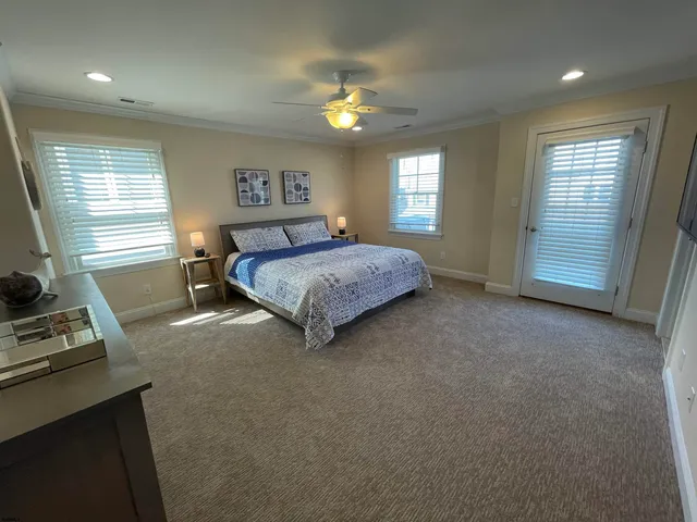 a spacious bedroom with a bed and a window