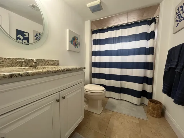 a bedroom with a bed a chandelier and a window