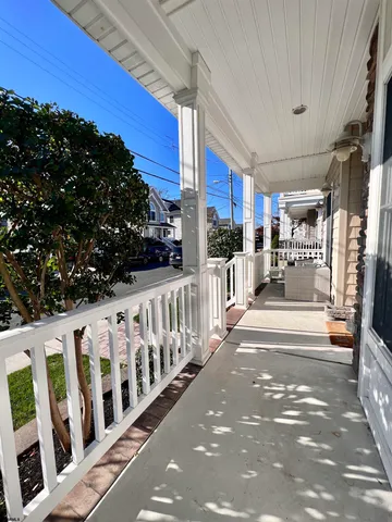 a view of a porch with wooden fence