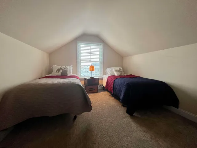 a bathroom with a sink a toilet a mirror and shower