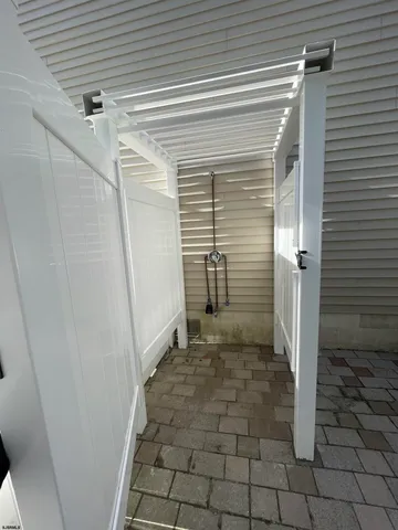 a view of a white house with a yard and plants