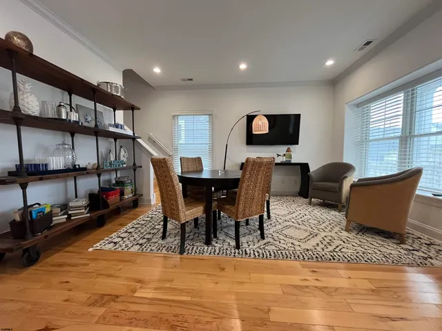 a living room with furniture a rug and a flat screen tv